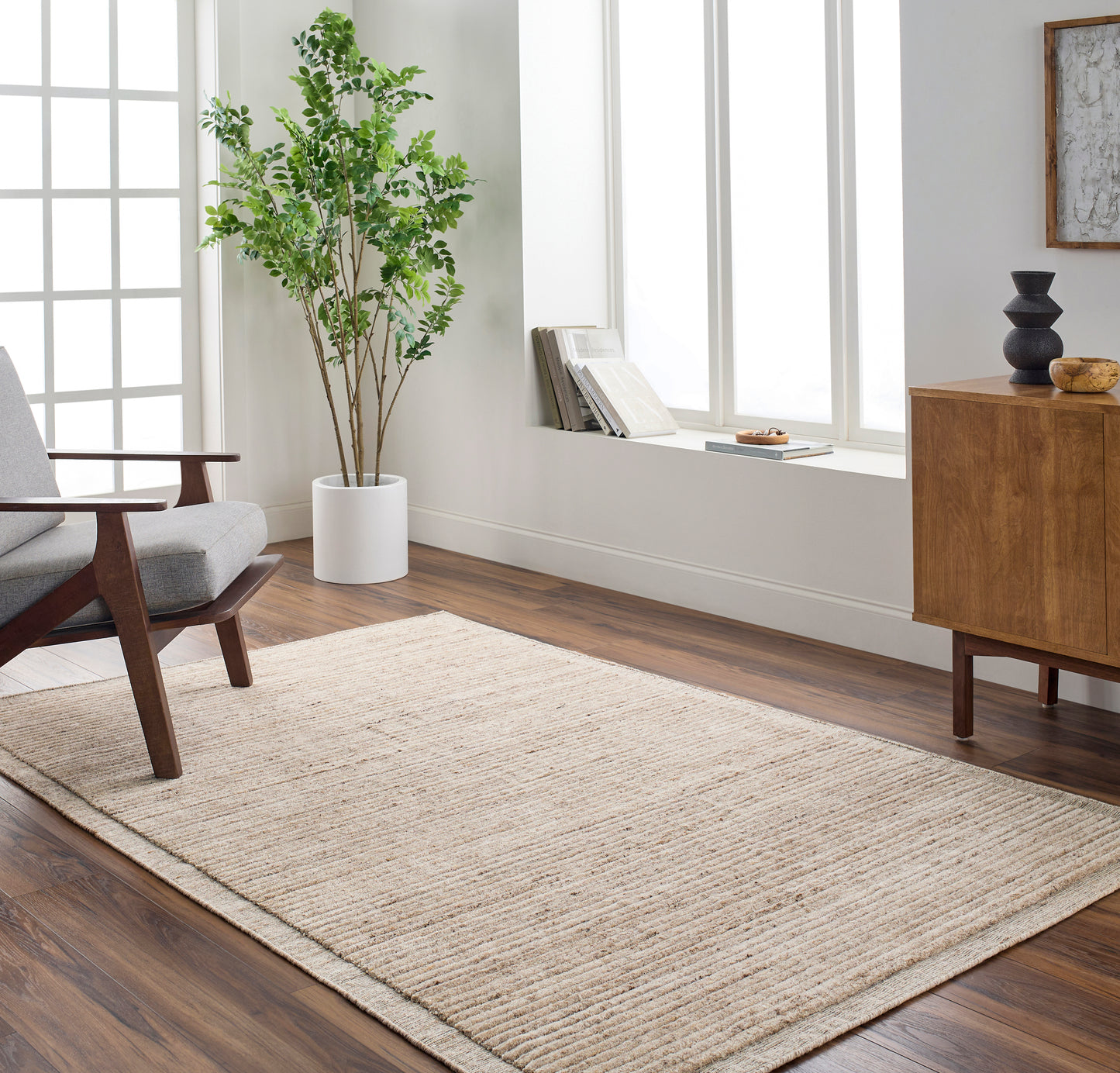 Surya Area rug under the chair in beige 